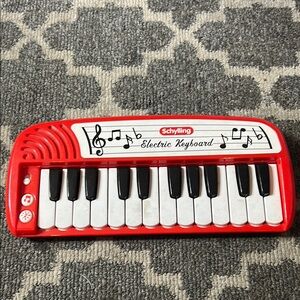 Red and White Electric Keyboard Toy